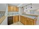 Basement bar area with wood cabinets, tile counters and unique lighting at 18885 E Union Dr, Aurora, CO 80015