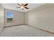 Cozy bedroom with soft carpet, ceiling fan, and a large window offering scenic views at 18885 E Union Dr, Aurora, CO 80015