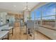 Bright dining area featuring a large window, stylish chandelier, and comfortable seating at 18885 E Union Dr, Aurora, CO 80015