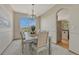 Traditional dining room with elegant chandelier, neutral tones, and large window overlooking the landscape at 18885 E Union Dr, Aurora, CO 80015