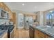 Well-equipped kitchen with stainless steel appliances, granite countertops, and an island with a sink at 18885 E Union Dr, Aurora, CO 80015