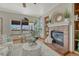 Cozy living room with a brick fireplace, large windows, and stylish decor with views to the outside deck at 18885 E Union Dr, Aurora, CO 80015