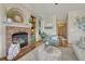 Bright living room with brick fireplace, hardwood floors, and stylish furniture at 18885 E Union Dr, Aurora, CO 80015