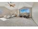 Serene main bedroom with vaulted ceilings, expansive window, and comfortable seating area at 18885 E Union Dr, Aurora, CO 80015