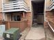 Attractive condo exterior with brick accents, a private patio, and convenient access to stairs and walkways at 3332 S Ammons St # 103, Lakewood, CO 80227
