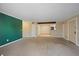 Spacious living room featuring neutral walls, plush carpet, and a beam ceiling at 3332 S Ammons St # 103, Lakewood, CO 80227