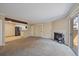Bright living room with a cozy fireplace, wood beam, and natural light from sliding doors at 3332 S Ammons St # 103, Lakewood, CO 80227