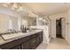 Bathroom features a granite countertop, dual sinks, and a glass shower at 7833 Bandit Dr, Castle Rock, CO 80108