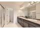 Bathroom features dual sinks with granite countertops and tiled floors at 7833 Bandit Dr, Castle Rock, CO 80108