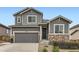 Charming two-story home showcasing a gray facade, stone accents, and a well-manicured front yard at 7833 Bandit Dr, Castle Rock, CO 80108