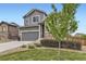 Landscaped front yard featuring a well-maintained lawn and a lovely two-story home with stone accents at 7833 Bandit Dr, Castle Rock, CO 80108