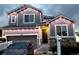 Two-story home with festive holiday lights, an attached garage, and stone accents at 7833 Bandit Dr, Castle Rock, CO 80108