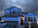 Attractive two-story home with blue holiday lights, solar panels, and landscaping at 7833 Bandit Dr, Castle Rock, CO 80108