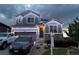 Beautiful home exterior adorned with modern white holiday lights and landscaping at 7833 Bandit Dr, Castle Rock, CO 80108