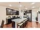 Stylish kitchen with a central island, granite countertops, stainless steel appliances, and dark wood cabinets at 7833 Bandit Dr, Castle Rock, CO 80108