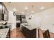 Bright kitchen featuring a granite island, stainless steel appliances, and modern lighting at 7833 Bandit Dr, Castle Rock, CO 80108