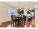 Kitchen and dining area with wood floors, dark wood cabinets, granite counters, and stainless steel appliances at 7833 Bandit Dr, Castle Rock, CO 80108
