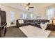 Living room with a large sectional sofa, a white rug, a ceiling fan and lots of natural light at 7833 Bandit Dr, Castle Rock, CO 80108
