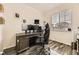 Well-lit office space with desk, large monitor, and window with blinds at 7833 Bandit Dr, Castle Rock, CO 80108