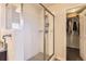 Modern shower stall with glass door, tiled walls, and built-in shelving at 7833 Bandit Dr, Castle Rock, CO 80108