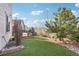 Green backyard featuring a deck, fence and landscape features at 311 Portmeirion Ln, Castle Rock, CO 80104