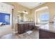 Well-lit bathroom featuring a large vanity sink and a soaking tub beneath a bright window at 311 Portmeirion Ln, Castle Rock, CO 80104