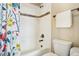 Bright bathroom featuring tiled shower and bathtub combination with decorative floral shower curtain at 311 Portmeirion Ln, Castle Rock, CO 80104