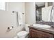 Bright bathroom featuring a tiled shower, modern fixtures, and vanity with tile backsplash at 311 Portmeirion Ln, Castle Rock, CO 80104
