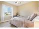 Cozy bedroom with comfortable bedding and a view from the window at 311 Portmeirion Ln, Castle Rock, CO 80104