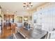 Open-concept dining area with hardwood floors, contemporary lighting, and views into the kitchen and living room at 311 Portmeirion Ln, Castle Rock, CO 80104