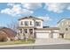 Charming two-story home with a three car garage and a welcoming front porch at 311 Portmeirion Ln, Castle Rock, CO 80104