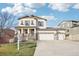 Charming two-story home with a three car garage and a welcoming front porch at 311 Portmeirion Ln, Castle Rock, CO 80104