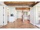 Open hallway with hardwood floors, beam ceilings and pendant lighting in a modern home at 311 Portmeirion Ln, Castle Rock, CO 80104