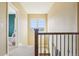 Hallway provides natural light and a peek into the living spaces beyond at 311 Portmeirion Ln, Castle Rock, CO 80104