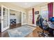 Bright home office with hardwood floors, French doors, and ample natural light at 311 Portmeirion Ln, Castle Rock, CO 80104
