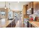 Well-equipped kitchen featuring stainless steel appliances, granite countertops, and a cozy dining area at 311 Portmeirion Ln, Castle Rock, CO 80104