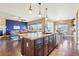 Kitchen featuring an island with seating overlooking the living room and dining area at 311 Portmeirion Ln, Castle Rock, CO 80104