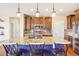 Spacious kitchen with a large island, pendant lighting, granite countertops, and stainless steel appliances at 311 Portmeirion Ln, Castle Rock, CO 80104