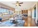 Inviting living room with hardwood floors, comfortable seating, and large windows offering plenty of natural light at 311 Portmeirion Ln, Castle Rock, CO 80104
