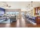 Open floor plan with living room, dining area, and kitchen featuring hardwood floors at 311 Portmeirion Ln, Castle Rock, CO 80104