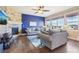 Cozy living room with stone fireplace, plush seating, and natural light from large windows at 311 Portmeirion Ln, Castle Rock, CO 80104