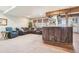 Open concept living room area featuring bar seating and an adjacent entertainment area at 311 Portmeirion Ln, Castle Rock, CO 80104