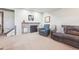 Cozy living room area features a fireplace and comfortable seating with an adjacent entertainment space at 311 Portmeirion Ln, Castle Rock, CO 80104