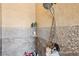 Updated shower with stylish tilework, a showerhead, and practical shelving at 311 Portmeirion Ln, Castle Rock, CO 80104
