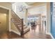 Open staircase with hardwood floors leading to a sun-filled living room at 311 Portmeirion Ln, Castle Rock, CO 80104