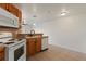 Bright kitchen featuring appliances, backsplash, and open layout to dining room at 5425 County Road 32 # 14, Mead, CO 80504