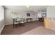 Bright community space featuring two windows with blinds, neutral carpet, and kitchen access at 5425 County Road 32 # 14, Mead, CO 80504