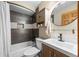 Bathroom featuring updated vanity, modern fixtures, and tiled shower/tub combination at 9239 Black Mountain Dr, Conifer, CO 80433