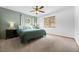 Comfortable bedroom with carpet flooring, a ceiling fan, and a view of the outside at 9239 Black Mountain Dr, Conifer, CO 80433