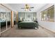 Serene primary bedroom with plush carpet, a ceiling fan, and picturesque views at 9239 Black Mountain Dr, Conifer, CO 80433